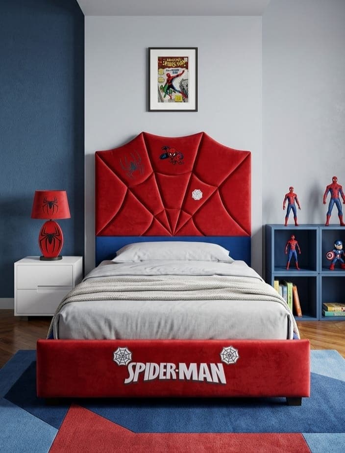 Spider-Man Bed styled in a blue and grey room, its red velvet headboard shaped into angular web panels above a blue upholstered base and a red footboard